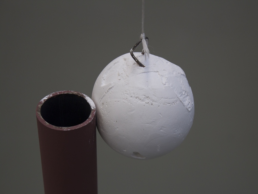 a plaster ball, slowly rubbing a metal pole