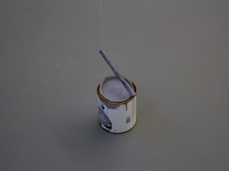 a tin of grey paint and a dancing grey stick